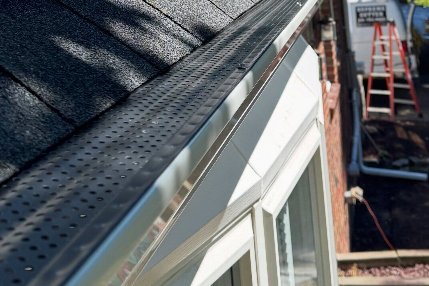Gutter guard fitted along a shingle roof edge in Salem, Oregon